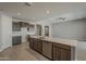 Kitchen island featuring stainless steel appliances, brown cabinets and white countertop at 18766 N Salerno Dr, Maricopa, AZ 85138