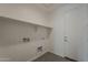 Laundry room with tile flooring and multiple white utility hookups at 18766 N Salerno Dr, Maricopa, AZ 85138