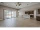Open-concept living space with tile flooring, neutral walls, and access to the backyard at 18766 N Salerno Dr, Maricopa, AZ 85138