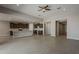 Spacious open-concept kitchen and living area with modern finishes and tile floors at 18766 N Salerno Dr, Maricopa, AZ 85138