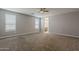 A carpeted primary bedroom featuring neutral paint, recessed lighting, and a large window at 18766 N Salerno Dr, Maricopa, AZ 85138