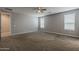Primary bedroom featuring neutral paint, recessed lighting, a ceiling fan and large windows at 18766 N Salerno Dr, Maricopa, AZ 85138