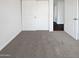 Cozy bedroom with neutral carpet and a closet with sliding doors at 1901 E Hearn Rd, Phoenix, AZ 85022