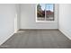 Bright bedroom with neutral carpet and a window offering a neighborhood view at 1901 E Hearn Rd, Phoenix, AZ 85022