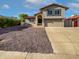 Charming two-story home with a well-maintained front yard and attached two-car garage at 1901 E Hearn Rd, Phoenix, AZ 85022