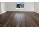 A living room with beautiful wood floors and a large window offering neighborhood views at 1901 E Hearn Rd, Phoenix, AZ 85022