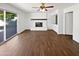 Spacious living room features hardwood flooring, a fireplace, and sliding doors to the backyard at 1901 E Hearn Rd, Phoenix, AZ 85022