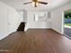 Spacious living area with hardwood floors, view of kitchen, and access to backyard at 1901 E Hearn Rd, Phoenix, AZ 85022