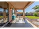 Inviting covered patio area with outdoor seating and view of landscaped backyard at 19318 E Reins Rd, Queen Creek, AZ 85142