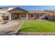 Expansive backyard with manicured lawn, patio, and desert landscaping at 19318 E Reins Rd, Queen Creek, AZ 85142