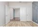 Bedroom featuring view into an adjacent room, open white doors, and modern flooring at 19318 E Reins Rd, Queen Creek, AZ 85142