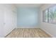 Bedroom featuring a large window, closet with white doors, and a cool blue wall at 19318 E Reins Rd, Queen Creek, AZ 85142