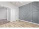 Bedroom featuring white closet doors, and gray accent wall at 19318 E Reins Rd, Queen Creek, AZ 85142