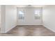 Bright, empty bedroom with wood-look flooring, neutral walls, and natural light at 19318 E Reins Rd, Queen Creek, AZ 85142