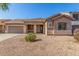 Charming single-story home featuring a well-maintained front yard and a two-car garage at 19318 E Reins Rd, Queen Creek, AZ 85142