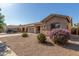 Charming single-story home with desert landscaping and a three-car garage at 19318 E Reins Rd, Queen Creek, AZ 85142