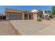Attractive single-Gathering home with a spacious driveway and well-manicured front yard at 19318 E Reins Rd, Queen Creek, AZ 85142