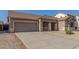 Well-maintained single-Gathering home with a spacious driveway and a front porch at 19318 E Reins Rd, Queen Creek, AZ 85142