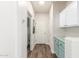 Hallway featuring cabinets, a laundry area, and an exit door at 19318 E Reins Rd, Queen Creek, AZ 85142
