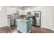Stylish kitchen with stainless steel appliances, an island, and white cabinetry at 19318 E Reins Rd, Queen Creek, AZ 85142