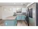 Kitchen features white cabinets and stainless steel appliances, plus island with countertop at 19318 E Reins Rd, Queen Creek, AZ 85142