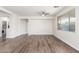 Spacious living room boasts stylish flooring and a large window with great natural light at 19318 E Reins Rd, Queen Creek, AZ 85142