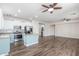 Spacious open-concept living area with kitchen, wood-look floors, and stainless steel appliances at 19318 E Reins Rd, Queen Creek, AZ 85142