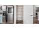 Stainless steel refrigerator and a white pantry shelves behind a white door at 19318 E Reins Rd, Queen Creek, AZ 85142