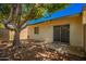 Backyard featuring a large mature tree, a storage shed, and a sliding glass door at 1951 E Del Sur Dr, Tempe, AZ 85283