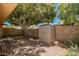 Private backyard featuring a storage shed, mature trees, and shade at 1951 E Del Sur Dr, Tempe, AZ 85283