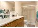Bathroom featuring a vanity, mirror, shower with glass door, and essential toiletries at 1951 E Del Sur Dr, Tempe, AZ 85283
