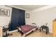 Simple bedroom features wood-look flooring, blue curtains, and a work-from-home space at 1951 E Del Sur Dr, Tempe, AZ 85283