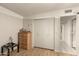 Well-lit bedroom featuring wood-look flooring, closet doors, and neutral walls at 1951 E Del Sur Dr, Tempe, AZ 85283