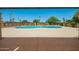 Beautiful community pool area with clear blue water and surrounding mature landscaping at 1951 E Del Sur Dr, Tempe, AZ 85283