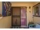 Enclosed front porch featuring a decorated security door, artwork, and a cozy seating area at 1951 E Del Sur Dr, Tempe, AZ 85283