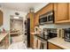 Kitchen with stainless steel appliances, wood cabinets, and an open view into the dining area at 1951 E Del Sur Dr, Tempe, AZ 85283