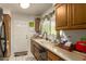 Traditional style kitchen featuring wood cabinets, a sink, and a door to the outside at 1951 E Del Sur Dr, Tempe, AZ 85283