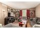 Cozy living room with bookshelves, comfortable seating, and natural light from the window at 1951 E Del Sur Dr, Tempe, AZ 85283