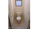 Cozy half bath featuring tiled floors and a white toilet with a window above at 1970 W Park Pl, Chandler, AZ 85224