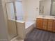 Bathroom featuring an enclosed shower and tub combination next to a double sink vanity at 1970 W Park Pl, Chandler, AZ 85224
