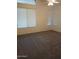 Bright, open bedroom featuring plush carpeting and large windows with blinds at 1970 W Park Pl, Chandler, AZ 85224