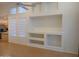 Bright and airy living room with large windows, built-in shelving, and a ceiling fan at 1970 W Park Pl, Chandler, AZ 85224