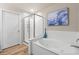Bathroom featuring a soaking tub, a walk-in glass shower, art, and tile flooring at 19700 N 76Th St # 1038, Scottsdale, AZ 85255