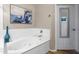 Inviting bathroom showcasing a luxurious soaking tub, art, and tile flooring at 19700 N 76Th St # 1038, Scottsdale, AZ 85255