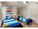 Bedroom featuring two twin beds with colorful bedding, closet, and ample natural light at 19700 N 76Th St # 1038, Scottsdale, AZ 85255