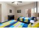 Bedroom featuring twin beds with colorful bedding, neutral walls, and a window at 19700 N 76Th St # 1038, Scottsdale, AZ 85255