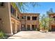 Inviting condo with a two-car garage and stone accents. Stairway entrance to the unit at 19700 N 76Th St # 1038, Scottsdale, AZ 85255
