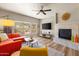 Inviting living room boasts a fireplace, a TV, and bright, natural light at 19700 N 76Th St # 1038, Scottsdale, AZ 85255