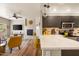 Open-concept living room showcasing a fireplace, modern kitchen, and bar seating at 19700 N 76Th St # 1038, Scottsdale, AZ 85255