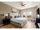 Cozy primary bedroom with a king bed, wood floors, and relaxing natural light at 19700 N 76Th St # 1038, Scottsdale, AZ 85255